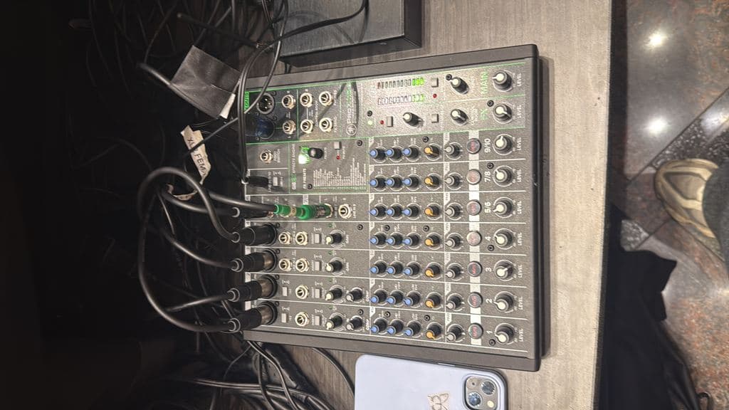 Close-up of an audio mixing board mid-event
