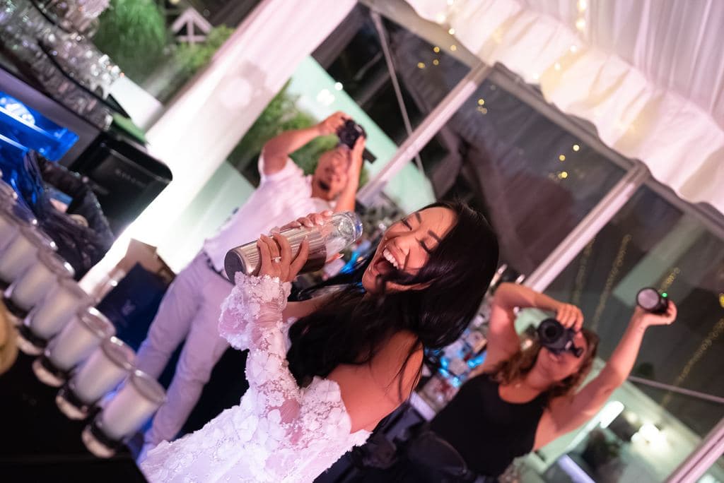 Bride dancing and spraying champagne on the dance floor