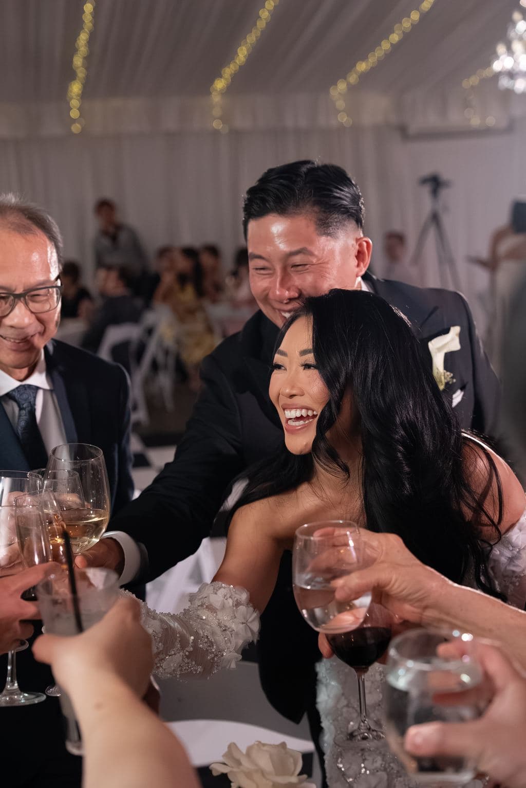 A guest embracing the bride during a reception toast