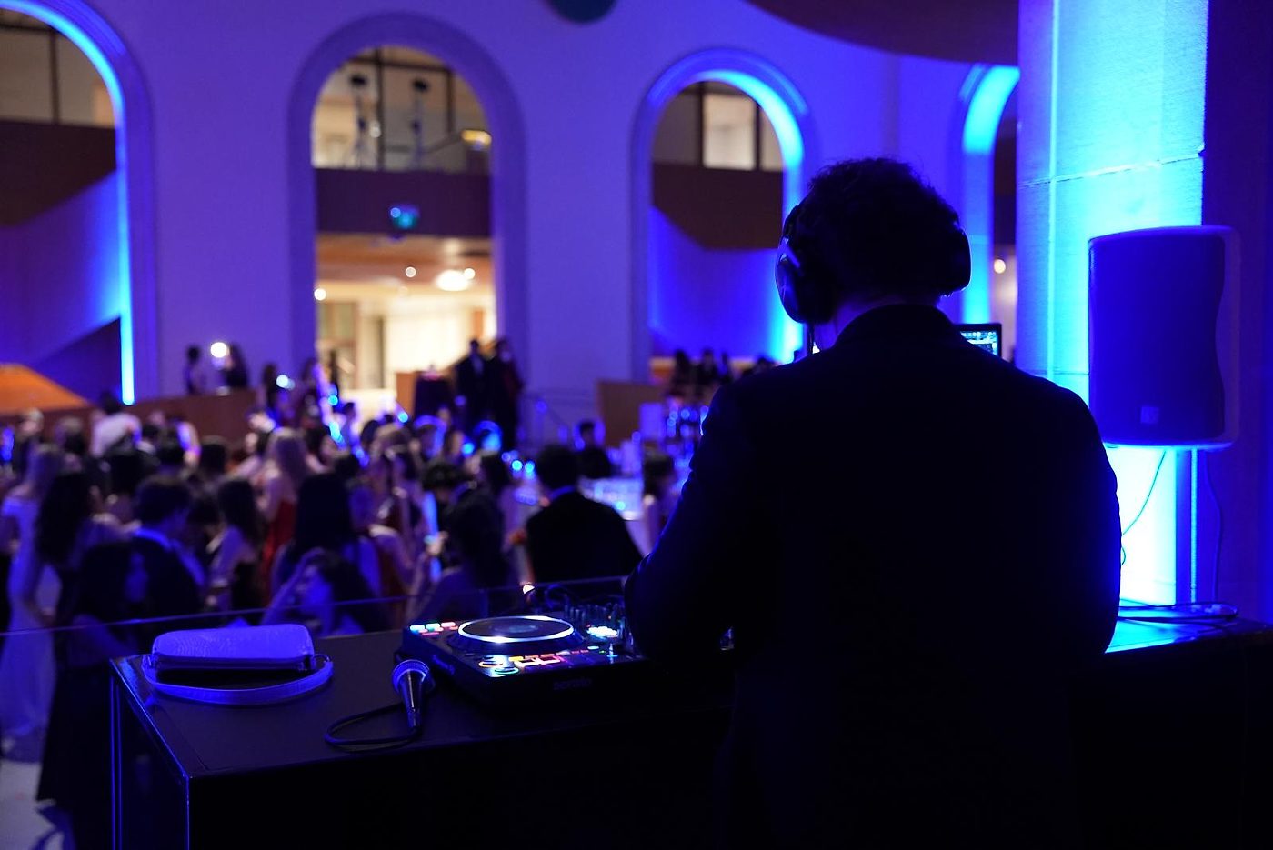 DJ at the booth mid-set, over the crowd